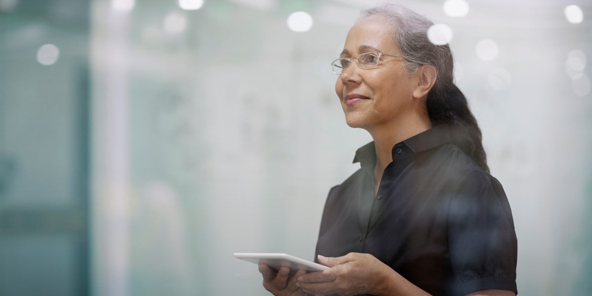 woman in office with phone in hands