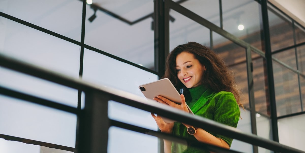 woman in office holding tablet