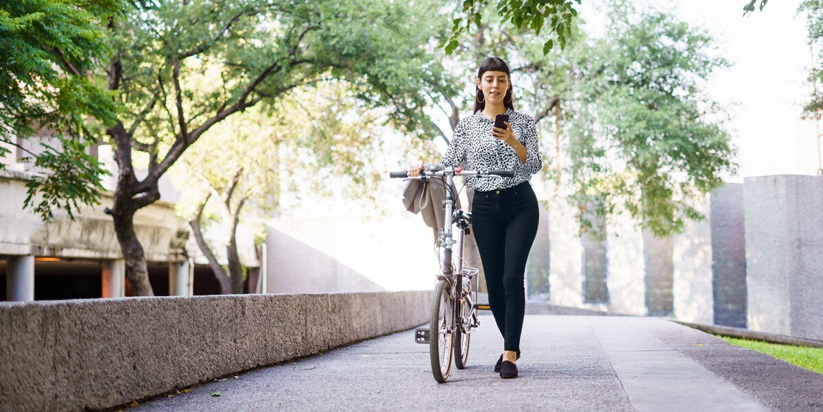 woman with bicycle outdoors