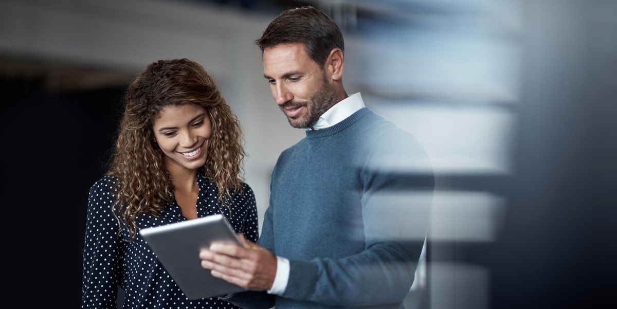 two professionals in office reviewing document