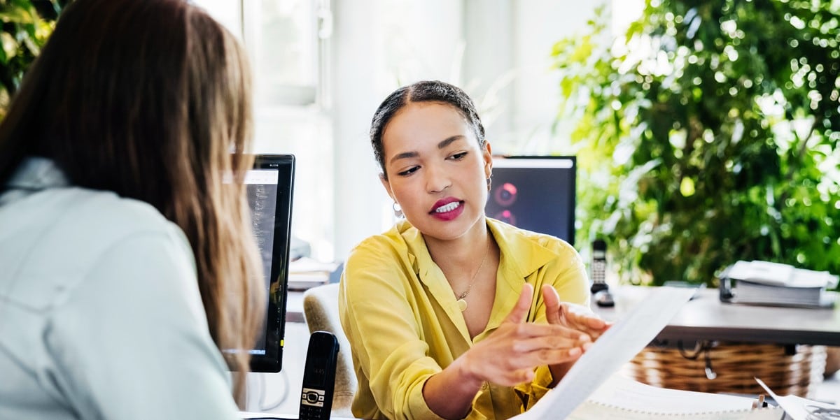 woman in office pointing to document