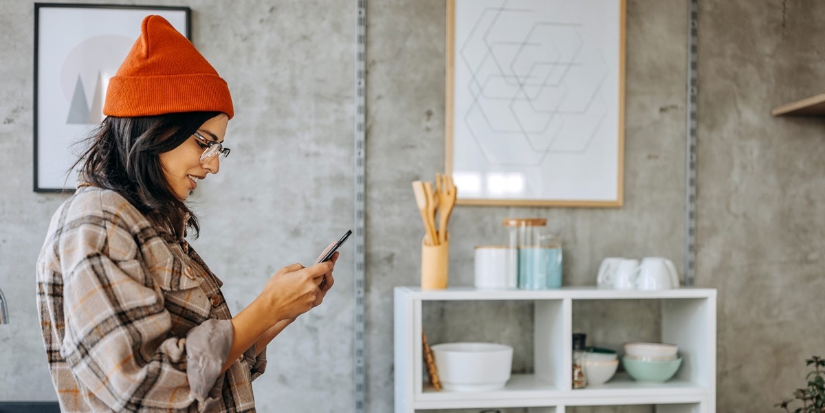 woman in office looking down at phone