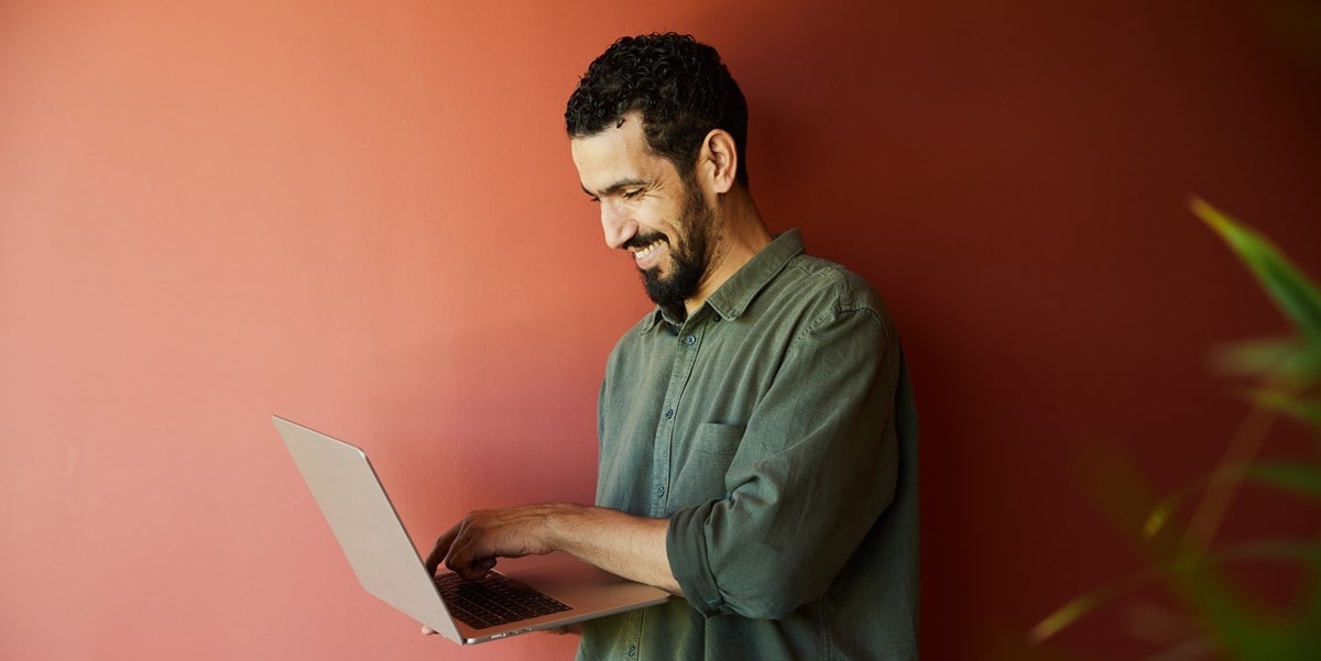 man looking down at laptop